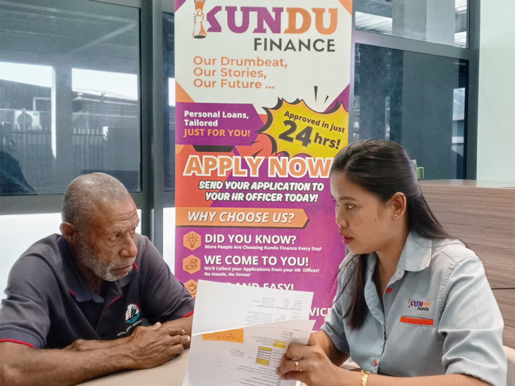 Kundu Finance Staff assisting an elderly man who needs financial assistance